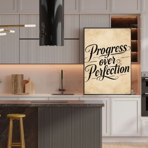 Modern kitchen with 'Progress over Perfection' poster on the wall