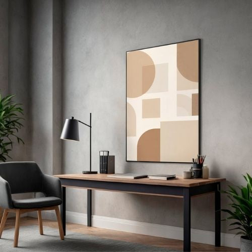 Modern office setup with a desk, chair, lamp, and abstract art on a gray wall.