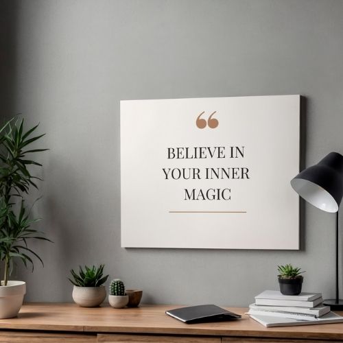 Motivational poster with 'Believe in Your Inner Magic' quote on a wall above a desk with plants and books.