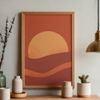 Decorative wall art with a sunset design on a wooden frame, placed on a shelf.