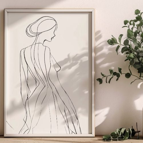 Framed line art of a woman's silhouette on a wall with a plant