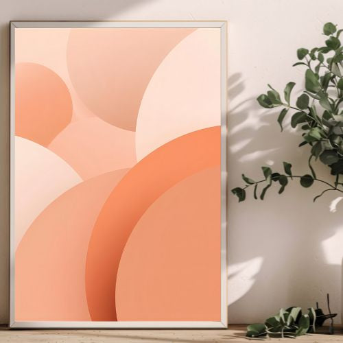 Framed abstract art with orange and pink circles on a white wall.