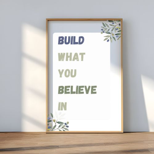 Framed poster with motivational quote 'Build What You Believe In' on a white background with floral elements.