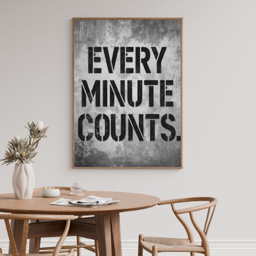 Dining room with a framed poster on the wall displaying 'Every Minute Counts'.