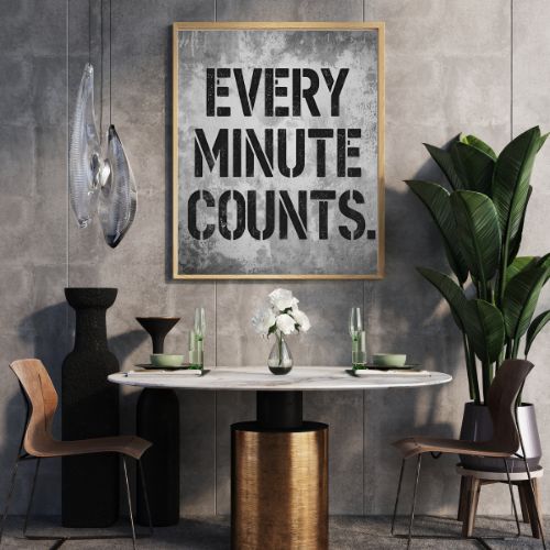 Dining room with marble table, chairs, and a motivational poster on the wall.
